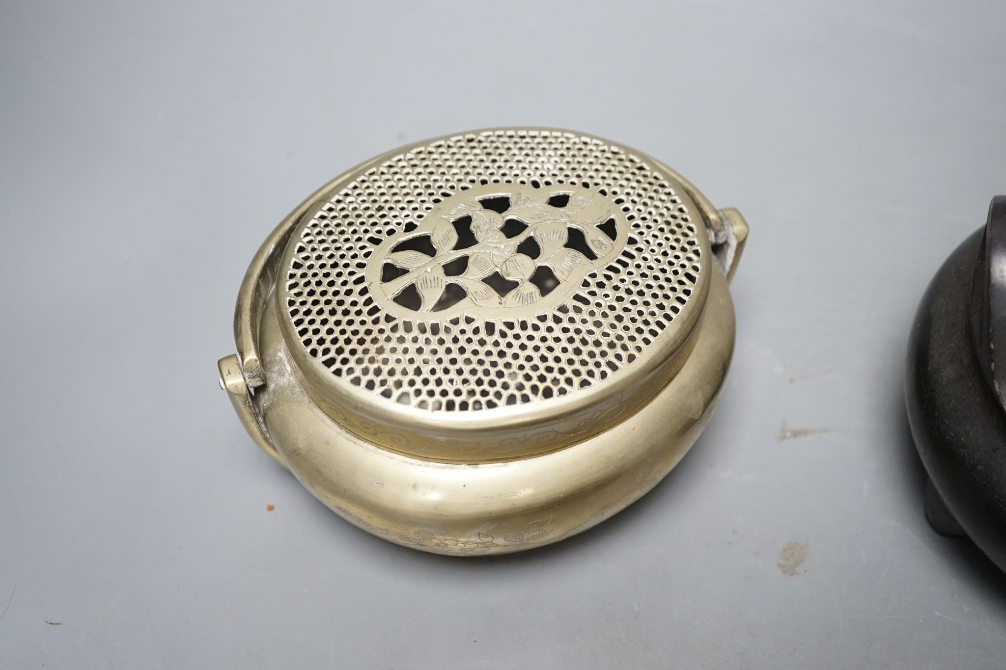 A Chinese bronze tripod censer, 13.5cm and two brass or bronze hand warmers